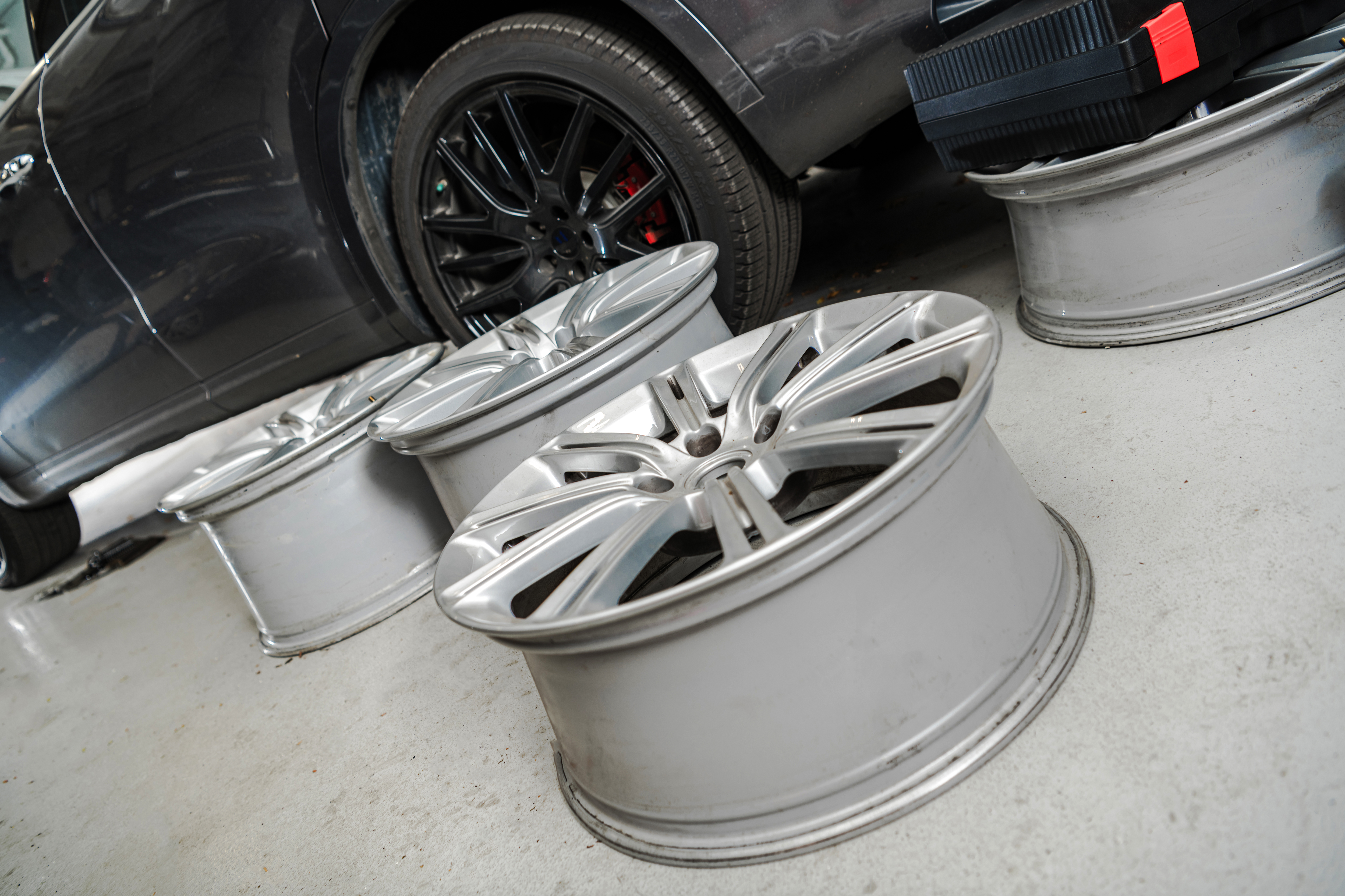 Modern Car Alloy Wheels Replacement Inside Auto Service Center. Automotive Industry Theme.